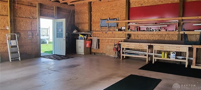 289 Dayton Ave, Xenia, OH 45385 - misc room with a workshop area, concrete flooring, and wood walls