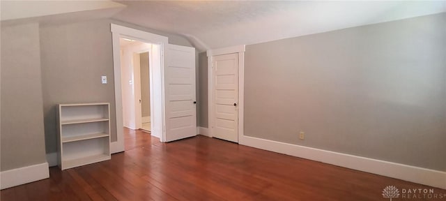 289 Dayton Ave, Xenia, OH 45385 - unfurnished bedroom featuring lofted ceiling, dark wood-type flooring, and a closet