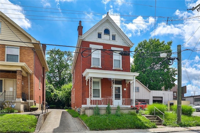 15 Bertus St, Cincinnati, OH 45217 - view of front facade featuring a porch, brick siding, and a chimney