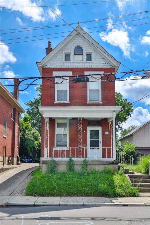 15 Bertus St, Cincinnati, OH 45217 - view of front of house with brick siding and covered porch