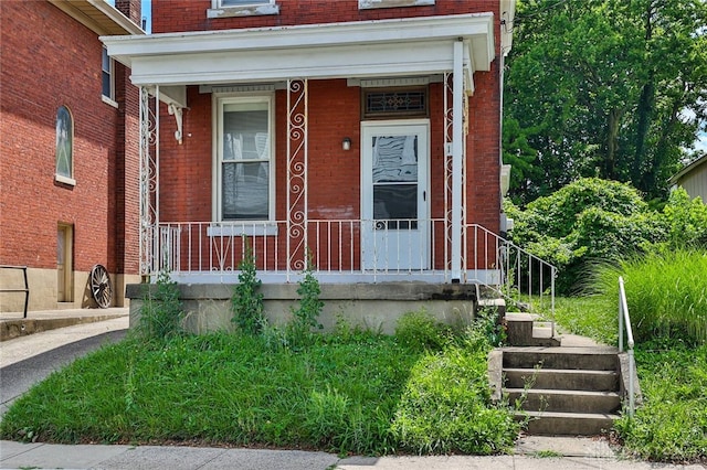 15 Bertus St, Cincinnati, OH 45217 - doorway to property with brick siding and covered porch
