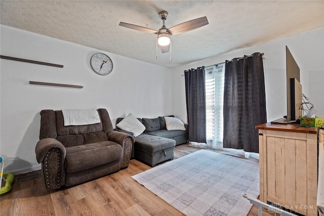 1227 Fyffe Ave, New Carlisle, OH 45344 - living room featuring wood finished floors and a ceiling fan