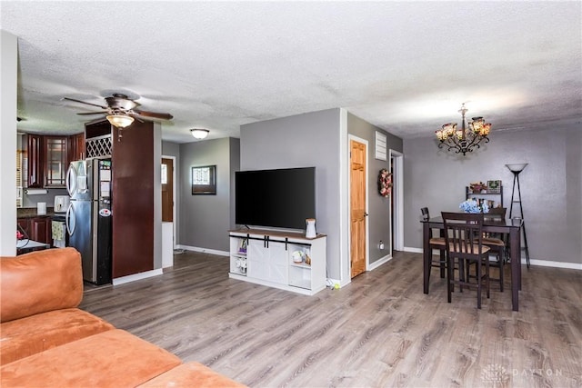 1221 Highview Dr, Fairborn, OH 45324 - living area featuring a textured ceiling, wood finished floors, a chandelier, and a ceiling fan
