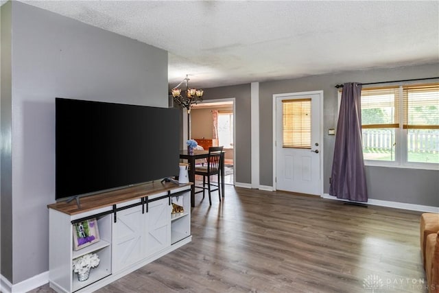 1221 Highview Dr, Fairborn, OH 45324 - living room with a chandelier, wood finished floors, and a textured ceiling
