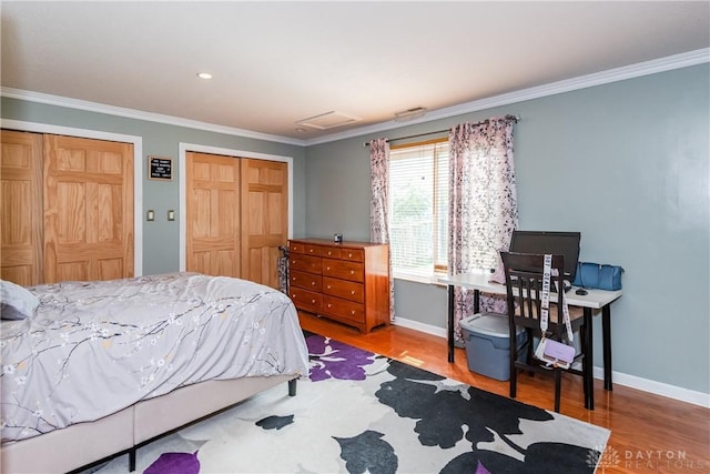 1221 Highview Dr, Fairborn, OH 45324 - bedroom with wood finished floors, crown molding, and multiple closets