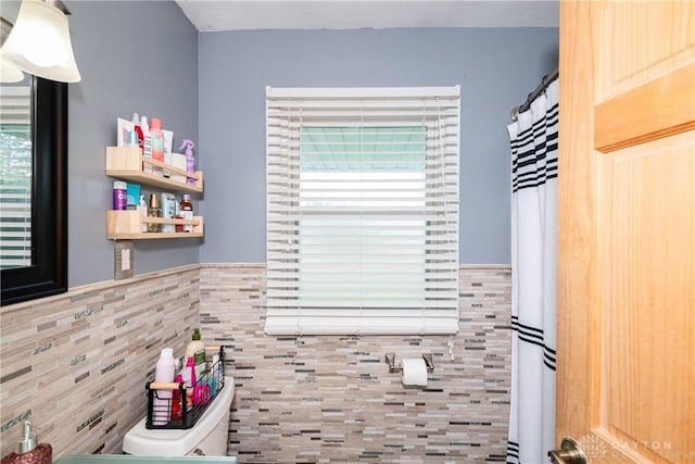 1221 Highview Dr, Fairborn, OH 45324 - full bath featuring tile walls, plenty of natural light, and a wainscoted wall