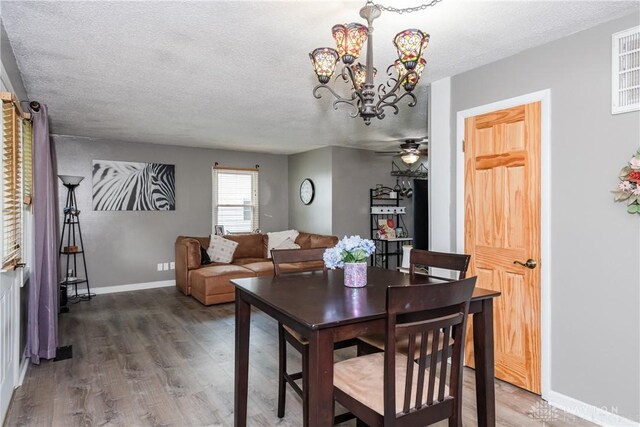 1221 Highview Dr, Fairborn, OH 45324 - dining room with a textured ceiling, wood finished floors, a chandelier, and a ceiling fan