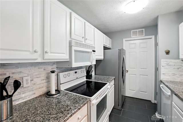 1720 Piper Ln Unit 104, Centerville, OH 45440 - kitchen with white appliances, tasteful backsplash, white cabinetry, dark tile patterned floors, and a textured ceiling