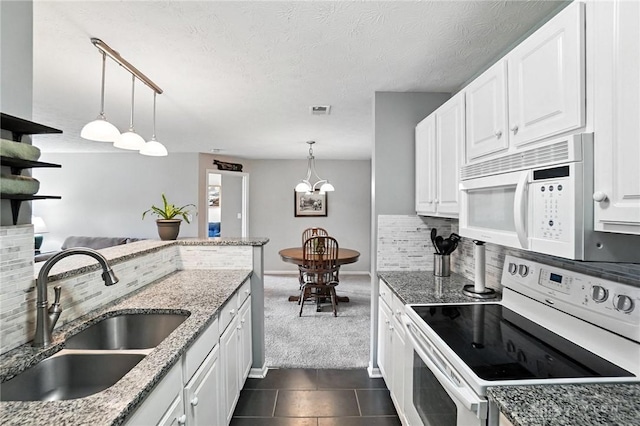 1720 Piper Ln Unit 104, Centerville, OH 45440 - kitchen with white appliances, backsplash, white cabinetry, dark carpet, and pendant lighting