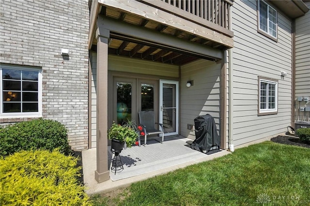 1720 Piper Ln Unit 104, Centerville, OH 45440 - property entrance featuring a balcony, a lawn, and brick siding