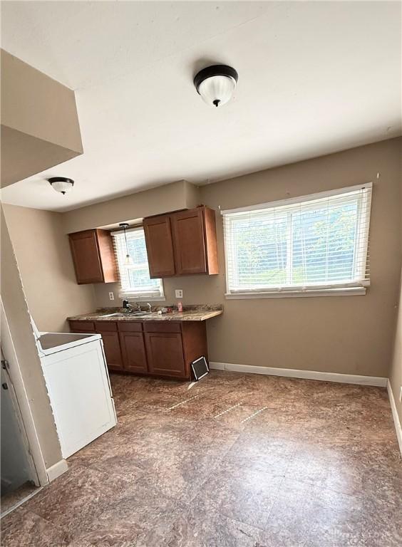 300 S Hayden Ave, Dayton, OH 45431 - kitchen with brown cabinets and washer / dryer