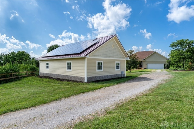 1590 Fairground Rd, Xenia, OH 45385 - view of home's exterior with roof mounted solar panels, a metal roof, and a standing seam roof