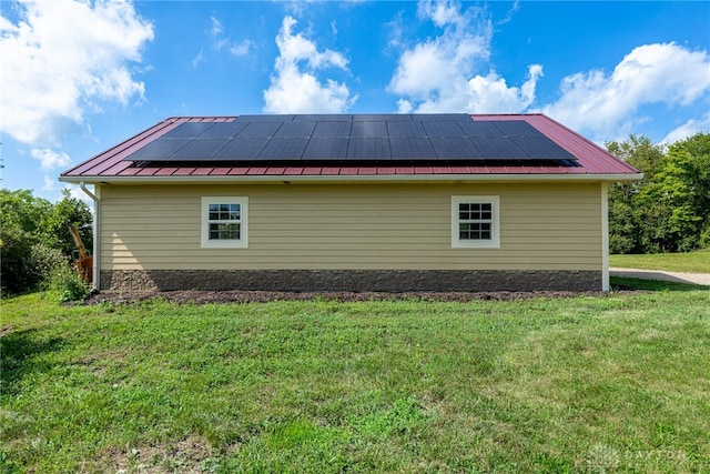 1590 Fairground Rd, Xenia, OH 45385 - view of home's exterior with solar panels, a yard, a standing seam roof, and a metal roof