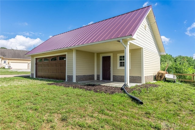 1590 Fairground Rd, Xenia, OH 45385 - view of front of property featuring an attached garage, a metal roof, a front yard, and stone siding