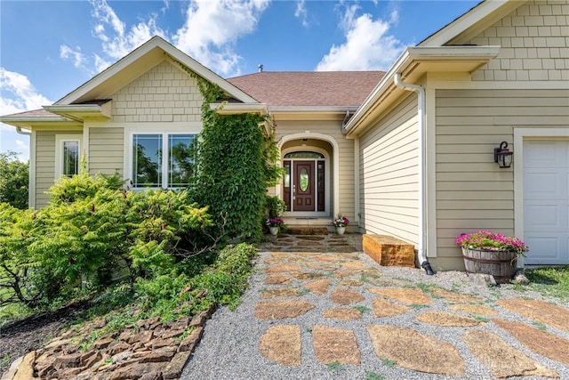 1590 Fairground Rd, Xenia, OH 45385 - view of exterior entry with a garage and a shingled roof