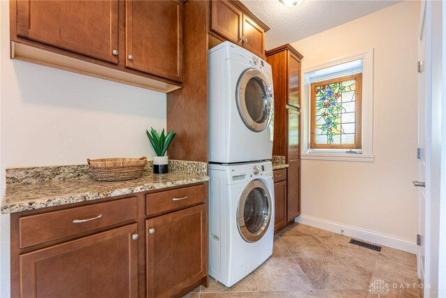 1590 Fairground Rd, Xenia, OH 45385 - laundry area with estacked washer and dryer and cabinet space