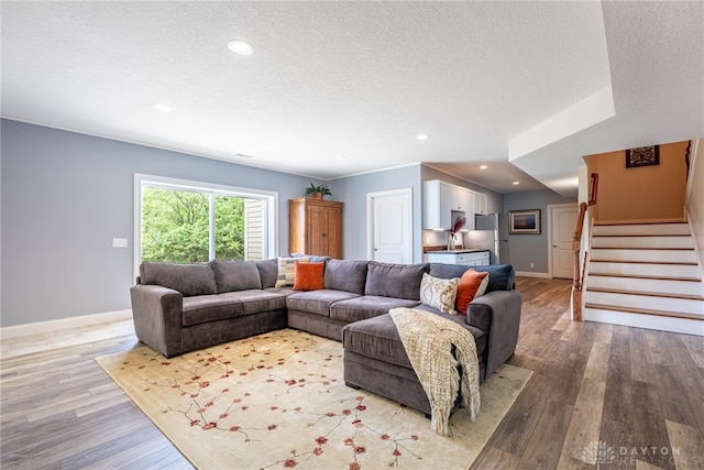 1590 Fairground Rd, Xenia, OH 45385 - living area with a textured ceiling, light wood-type flooring, stairway, and recessed lighting