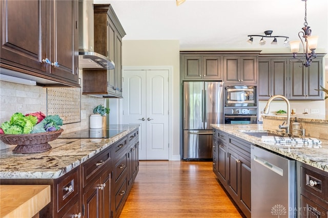1590 Fairground Rd, Xenia, OH 45385 - kitchen with stainless steel appliances, wall chimney range hood, dark brown cabinets, and light wood-style flooring