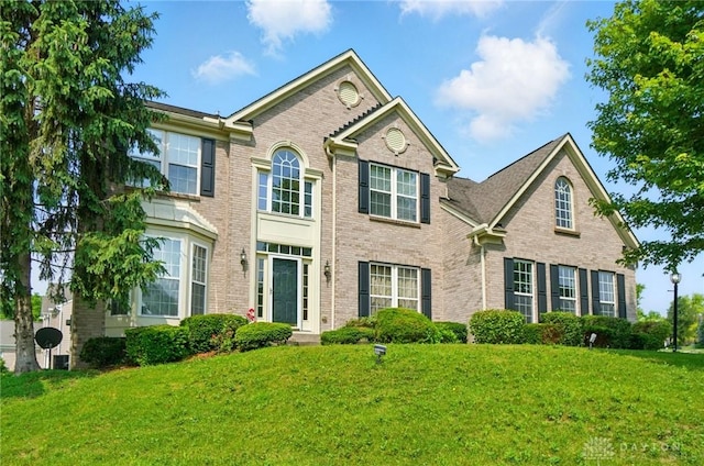 2435 Forest Oaks Dr, Beavercreek, OH 45431 - view of front of home with brick siding and a front yard
