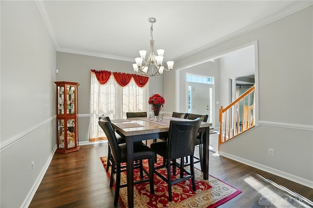 2435 Forest Oaks Dr, Beavercreek, OH 45431 - dining space with a chandelier, crown molding, dark wood finished floors, and stairs