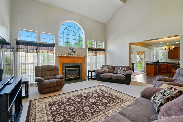 2435 Forest Oaks Dr, Beavercreek, OH 45431 - living area with high vaulted ceiling, a chandelier, and a tile fireplace