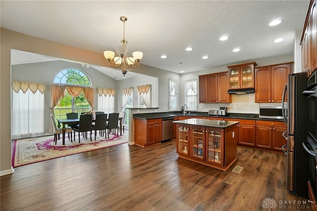 2435 Forest Oaks Dr, Beavercreek, OH 45431 - kitchen featuring stainless steel appliances, a chandelier, brown cabinetry, dark countertops, and recessed lighting