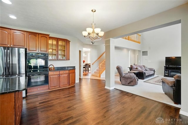 2435 Forest Oaks Dr, Beavercreek, OH 45431 - kitchen with freestanding refrigerator, glass insert cabinets, brown cabinetry, a chandelier, and recessed lighting