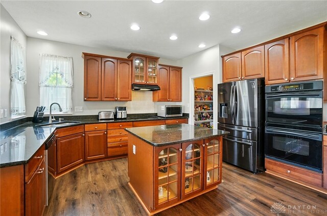2435 Forest Oaks Dr, Beavercreek, OH 45431 - kitchen featuring black appliances, dark wood-type flooring, recessed lighting, brown cabinets, and glass insert cabinets