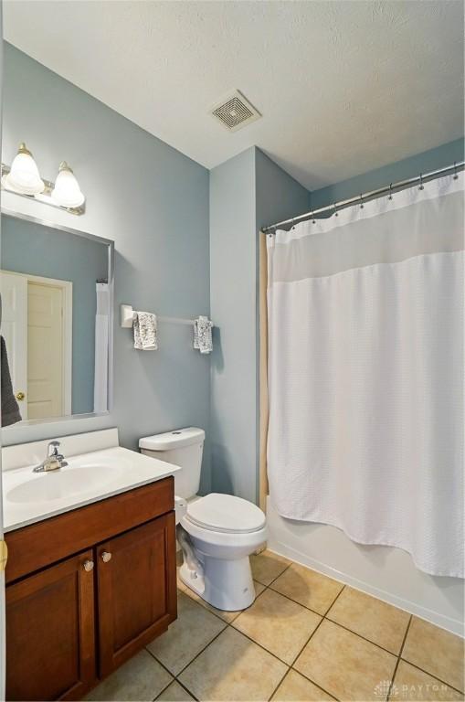 2435 Forest Oaks Dr, Beavercreek, OH 45431 - bathroom with vanity, tile patterned flooring, and shower / tub combo