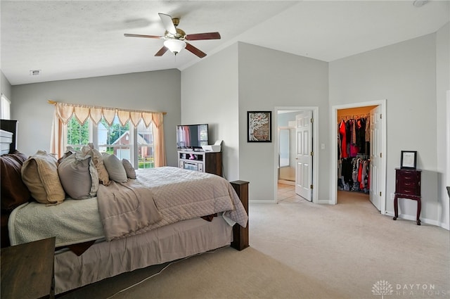 2435 Forest Oaks Dr, Beavercreek, OH 45431 - bedroom with a walk in closet, light carpet, ensuite bath, ceiling fan, and a closet