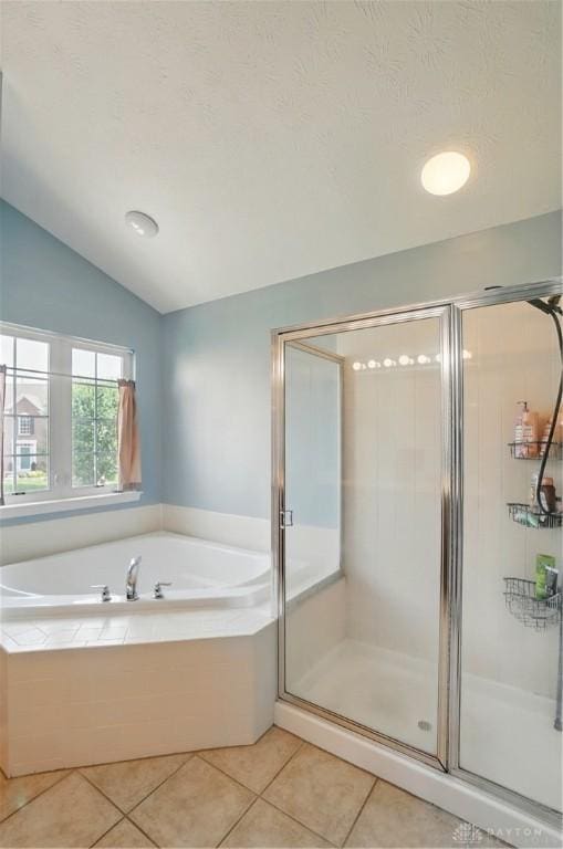 2435 Forest Oaks Dr, Beavercreek, OH 45431 - bathroom featuring a stall shower, a bath, vaulted ceiling, and tile patterned flooring