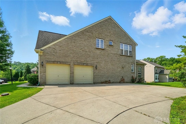 2435 Forest Oaks Dr, Beavercreek, OH 45431 - view of side of home featuring brick siding, concrete driveway, a lawn, roof with shingles, and an attached garage