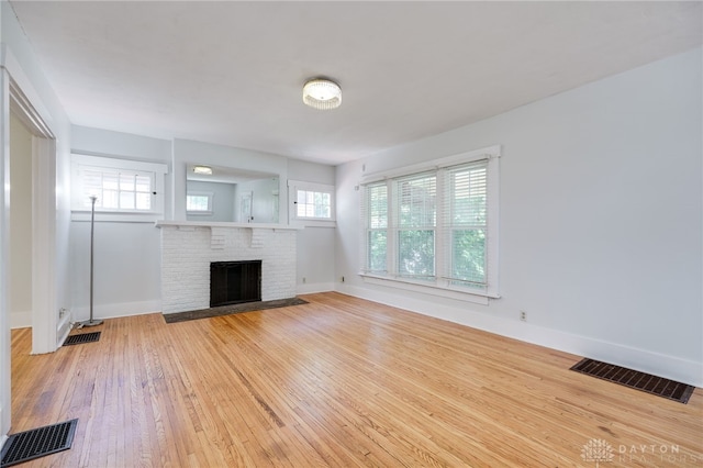 25 Laura Ave, Dayton, OH 45405 - unfurnished living room featuring light wood-type flooring and a fireplace