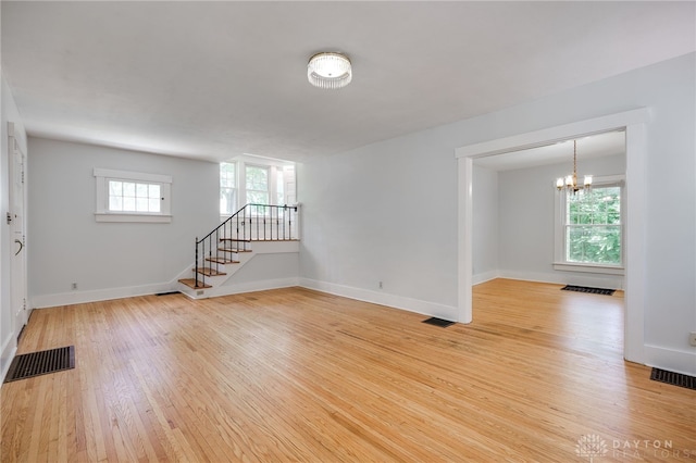 25 Laura Ave, Dayton, OH 45405 - spare room featuring light wood finished floors, a chandelier, and stairway