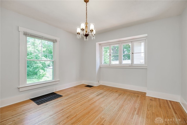 25 Laura Ave, Dayton, OH 45405 - empty room with plenty of natural light, a chandelier, and wood finished floors