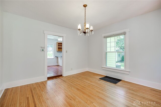 25 Laura Ave, Dayton, OH 45405 - unfurnished room with light wood-style floors, a chandelier, and ceiling fan