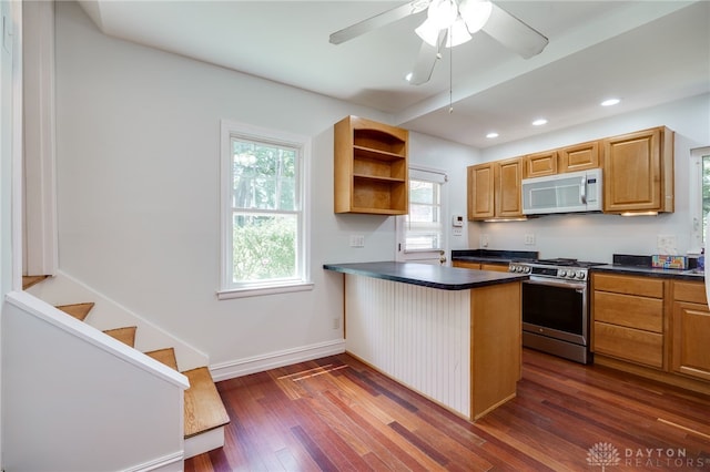 25 Laura Ave, Dayton, OH 45405 - kitchen with white microwave, stainless steel gas stove, dark countertops, open shelves, and a peninsula