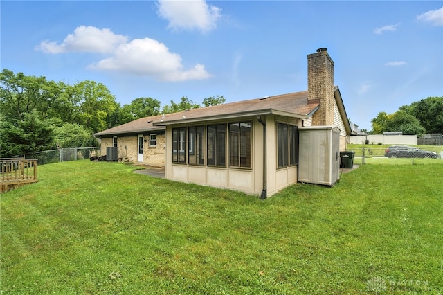 5 Bayberry Dr, Springboro, OH 45066 - rear view of property with a chimney, a fenced backyard, and a sunroom