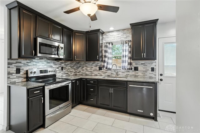 5 Bayberry Dr, Springboro, OH 45066 - kitchen with stainless steel appliances, light stone countertops, ceiling fan, and tasteful backsplash