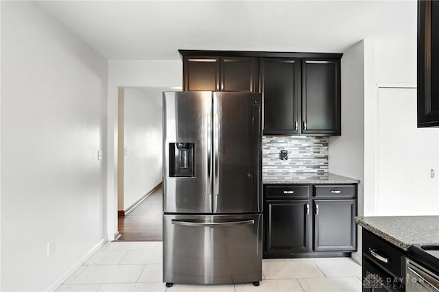 5 Bayberry Dr, Springboro, OH 45066 - kitchen featuring stainless steel fridge with ice dispenser, backsplash, light tile patterned floors, and stone countertops
