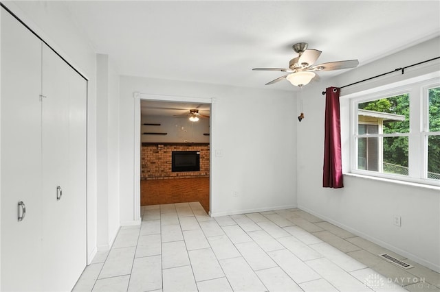 5 Bayberry Dr, Springboro, OH 45066 - spare room with a ceiling fan, a brick fireplace, and light tile patterned floors
