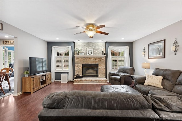 395 Victoria Pl, Waynesville, OH 45068 - living room featuring a ceiling fan, dark wood finished floors, healthy amount of natural light, a brick fireplace, and recessed lighting