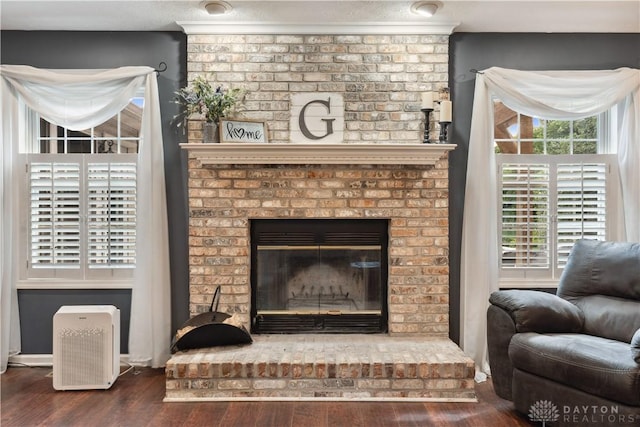 395 Victoria Pl, Waynesville, OH 45068 - living room featuring wood finished floors, a fireplace, and plenty of natural light
