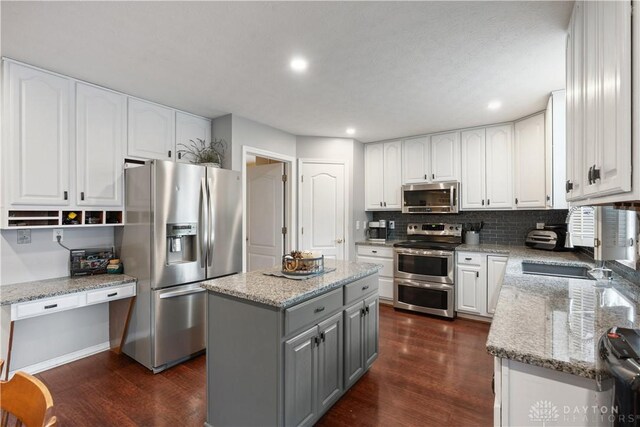 395 Victoria Pl, Waynesville, OH 45068 - kitchen with stainless steel appliances, gray cabinetry, dark wood-style floors, white cabinets, and recessed lighting