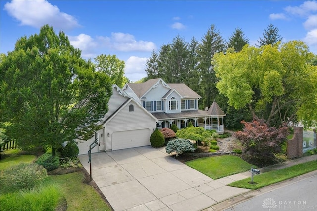 395 Victoria Pl, Waynesville, OH 45068 - view of front of house with an attached garage, driveway, and covered porch