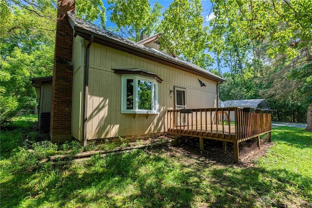 989 Ogden Rd, Adams Twp, OH 45177 - back of house with a chimney, a deck, and a yard