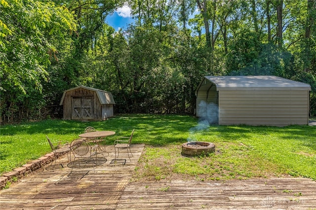 989 Ogden Rd, Adams Twp, OH 45177 - view of green lawn with a shed, an outdoor fire pit, and a wooden deck