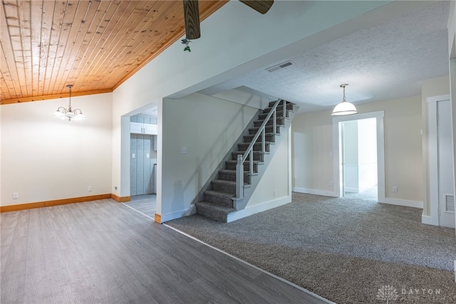 989 Ogden Rd, Adams Twp, OH 45177 - unfurnished living room featuring stairs, wood finished floors, wood ceiling, and a chandelier