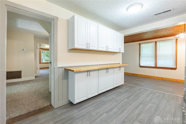 989 Ogden Rd, Adams Twp, OH 45177 - kitchen with wood counters, white cabinets, light wood-type flooring, and a textured ceiling