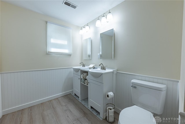 989 Ogden Rd, Adams Twp, OH 45177 - bathroom with vanity, a wainscoted wall, and wood finished floors